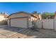 Attached two-car garage with automatic door, side door and brick-lined drive at 8709 W Roanoke Ave, Phoenix, AZ 85037