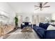 Inviting living room featuring stylish sofas, a wooden coffee table, and bright, natural lighting at 8709 W Roanoke Ave, Phoenix, AZ 85037