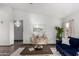 Bright living room with modern furnishings, attractive accent cabinet, and neutral décor at 8709 W Roanoke Ave, Phoenix, AZ 85037