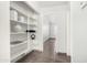 Bright pantry features open shelving and tile flooring at 8709 W Roanoke Ave, Phoenix, AZ 85037