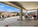 Inviting covered back patio perfect for outdoor dining and relaxation with a fire pit and a water feature at 9010 W Ruth Ave, Peoria, AZ 85345