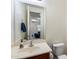 Cozy half-bath features a cream-colored vanity, a large mirror, and neutral paint, creating a clean, bright space at 9010 W Ruth Ave, Peoria, AZ 85345