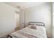 Cozy bedroom with neutral walls, a comfortable bed, and a decorative floral accent pillow at 9010 W Ruth Ave, Peoria, AZ 85345