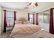 Primary bedroom featuring neutral walls, soft carpet, and windows with decorative curtains at 9010 W Ruth Ave, Peoria, AZ 85345