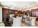 Modern kitchen featuring stainless steel appliances, a kitchen island, and stylish dark wood cabinets at 9010 W Ruth Ave, Peoria, AZ 85345