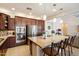 Stylish kitchen with stainless steel appliances, granite countertops, and a center island with bar seating at 9010 W Ruth Ave, Peoria, AZ 85345