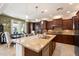 Spacious kitchen featuring granite island, stainless steel appliances and an eat-in dining area by large windows at 9010 W Ruth Ave, Peoria, AZ 85345