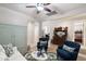 Inviting living room boasts neutral walls, tile floors, a ceiling fan, and views to the dining room at 9010 W Ruth Ave, Peoria, AZ 85345