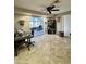 Functional home office featuring a sunroom, tile flooring, built-in shelving, and neutral walls at 9231 W Elkhorn Dr, Sun City, AZ 85351