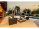 Inviting outdoor living space with fire pit, comfortable seating and pool views at 10105 E Larkspur Dr, Scottsdale, AZ 85260
