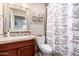 Bathroom featuring a vanity, toilet, and a shower with patterned curtains at 10105 E Larkspur Dr, Scottsdale, AZ 85260