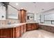 Bathroom featuring double sinks, granite counters, custom cabinets, and a soaking tub at 10105 E Larkspur Dr, Scottsdale, AZ 85260