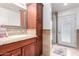 Bathroom featuring a vanity with granite counters and a tiled glass shower at 10105 E Larkspur Dr, Scottsdale, AZ 85260