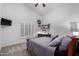 Bedroom showcases neutral walls, a ceiling fan, and a window with plantation shutters at 10105 E Larkspur Dr, Scottsdale, AZ 85260