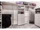 Walk-in closet with custom shelving and organization solutions for optimal storage and convenience at 10105 E Larkspur Dr, Scottsdale, AZ 85260