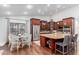 Eat-in kitchen featuring wood cabinets, granite countertops, stainless-steel appliances, and a breakfast nook at 10105 E Larkspur Dr, Scottsdale, AZ 85260