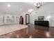 Bright living area with hardwood floors, arched windows with shutters, and decorative furnishings at 10105 E Larkspur Dr, Scottsdale, AZ 85260