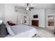 Bright primary bedroom with TV and en suite bathroom access for convenience at 10105 E Larkspur Dr, Scottsdale, AZ 85260
