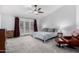 Bright primary bedroom boasts a ceiling fan and access to the backyard through French doors at 10105 E Larkspur Dr, Scottsdale, AZ 85260