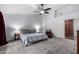Spacious main bedroom features neutral tones, a ceiling fan, and a comfortable sitting area at 10105 E Larkspur Dr, Scottsdale, AZ 85260