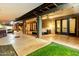 A covered patio features comfortable outdoor seating, tile flooring, and convenient access to the home's interior at 10105 E Larkspur Dr, Scottsdale, AZ 85260