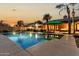 Backyard pool and patio area with palm trees, outdoor grill, and comfortable seating for entertaining guests at 10105 E Larkspur Dr, Scottsdale, AZ 85260