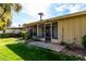 Cozy backyard with a screened-in porch and stone tile leading to grass at 11047 N Coggins Dr, Sun City, AZ 85351