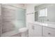 This bright bathroom features a sleek vanity and a shower with modern glass doors at 11047 N Coggins Dr, Sun City, AZ 85351