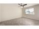 Bedroom with sleek tiled floors, a ceiling fan, and ample natural light at 11047 N Coggins Dr, Sun City, AZ 85351