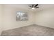This bright bedroom boasts neutral tones, wood-look flooring, and a ceiling fan at 11047 N Coggins Dr, Sun City, AZ 85351