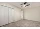 This bright bedroom features wood-look flooring, ceiling fan and double door closet at 11047 N Coggins Dr, Sun City, AZ 85351