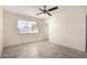 This bedroom boasts neutral tones, wood-look flooring, and a ceiling fan for added comfort at 11047 N Coggins Dr, Sun City, AZ 85351