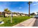 Charming home featuring mature trees, a well-manicured lawn, and a private sidewalk at 11047 N Coggins Dr, Sun City, AZ 85351