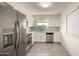 Modern kitchen with stainless steel appliances, white cabinets, and stylish backsplash at 11047 N Coggins Dr, Sun City, AZ 85351