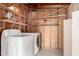 The laundry area includes washer and dryer hookups with shelving for extra storage at 11047 N Coggins Dr, Sun City, AZ 85351