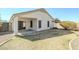 Backyard featuring partial grass, rock groundcover, covered patio, and sliding glass door at 1186 E Bradstock Way, San Tan Valley, AZ 85140