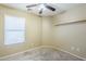 Bright bedroom with carpeted floors, a ceiling fan, and a light wood shelf at 1186 E Bradstock Way, San Tan Valley, AZ 85140
