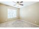 Cozy bedroom with neutral carpet, ceiling fan, and window with blinds at 1186 E Bradstock Way, San Tan Valley, AZ 85140