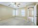 Light bedroom with neutral colors and a ceiling fan with carpet floors at 1186 E Bradstock Way, San Tan Valley, AZ 85140