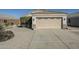 Attached garage with concrete driveway and desert landscaping in front yard at 1186 E Bradstock Way, San Tan Valley, AZ 85140