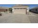 Home featuring a beige garage door, stone accents, and large concrete driveway at 1186 E Bradstock Way, San Tan Valley, AZ 85140
