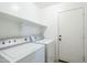 Convenient laundry room featuring a washer, dryer, and shelf above at 1186 E Bradstock Way, San Tan Valley, AZ 85140