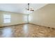 Bright living room with tiled floors, ceiling fan, and multiple windows at 1186 E Bradstock Way, San Tan Valley, AZ 85140