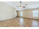 Living room with tiled floors, ceiling fan and multiple windows at 1186 E Bradstock Way, San Tan Valley, AZ 85140
