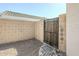 Side yard features a wooden gate, block wall, and rock groundcover at 1186 E Bradstock Way, San Tan Valley, AZ 85140