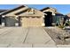 Home exterior with three-car garage and low water rock landscaping at 13804 W Marshall Ave, Litchfield Park, AZ 85340