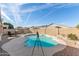 Backyard pool with brick border under a bright sky, view of neighborhood homes at 13804 W Marshall Ave, Litchfield Park, AZ 85340