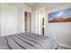 Modern bedroom features neutral decor, with a TV and doorways leading to other rooms of the house at 15921 E Ridgestone Dr, Fountain Hills, AZ 85268