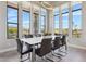 Bright dining room featuring large windows with mountain views, modern lighting and seating for eight at 15921 E Ridgestone Dr, Fountain Hills, AZ 85268