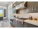 Close up view of the gourmet kitchen featuring gas range, custom vent hood, and subway tile backsplash at 15921 E Ridgestone Dr, Fountain Hills, AZ 85268